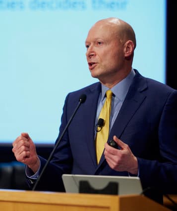 Mitch Zamoff speaking at a microphone
